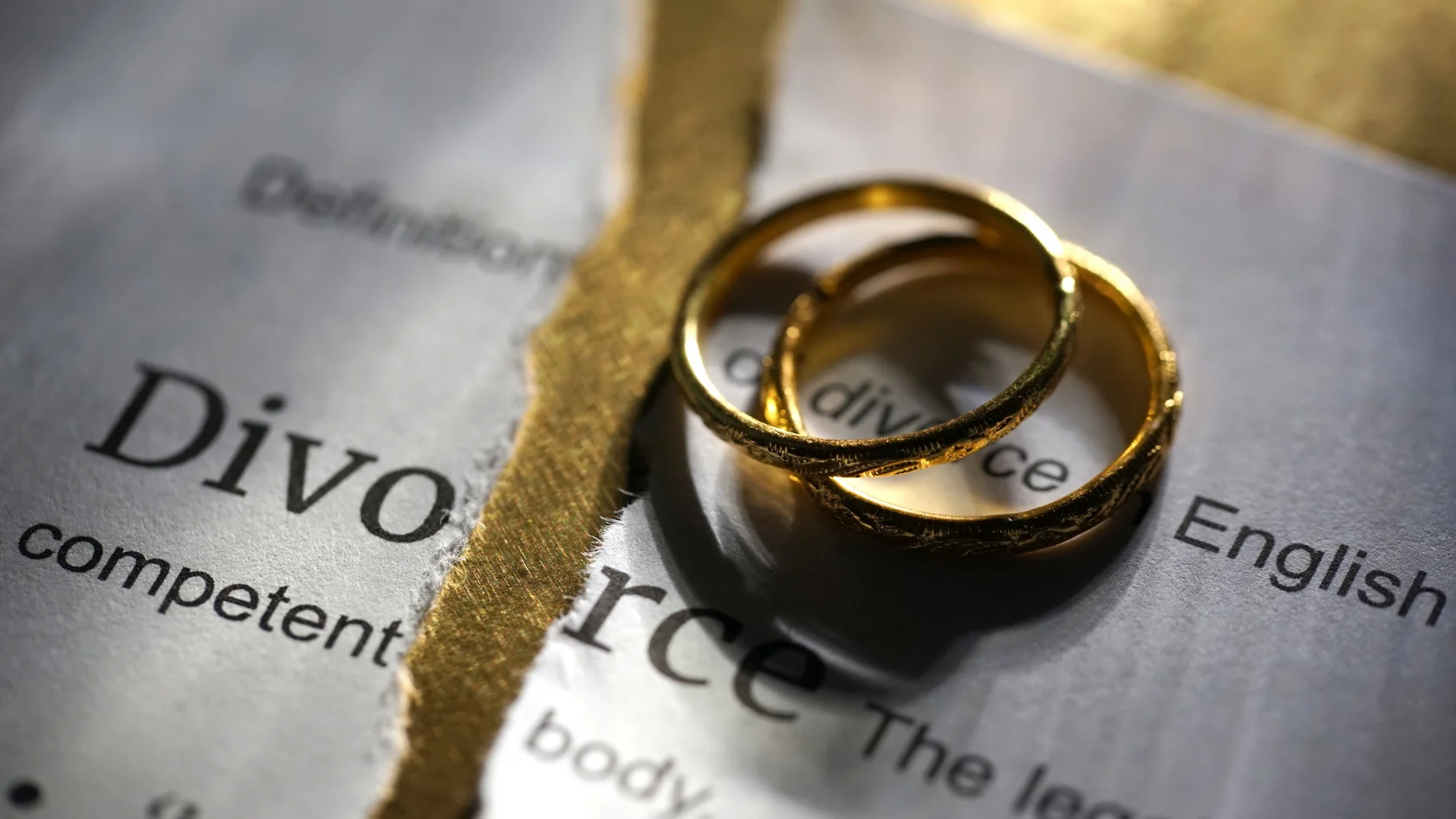 Wedding rings placed on divorce papers representing the legal process of ending a marriage in Canada.