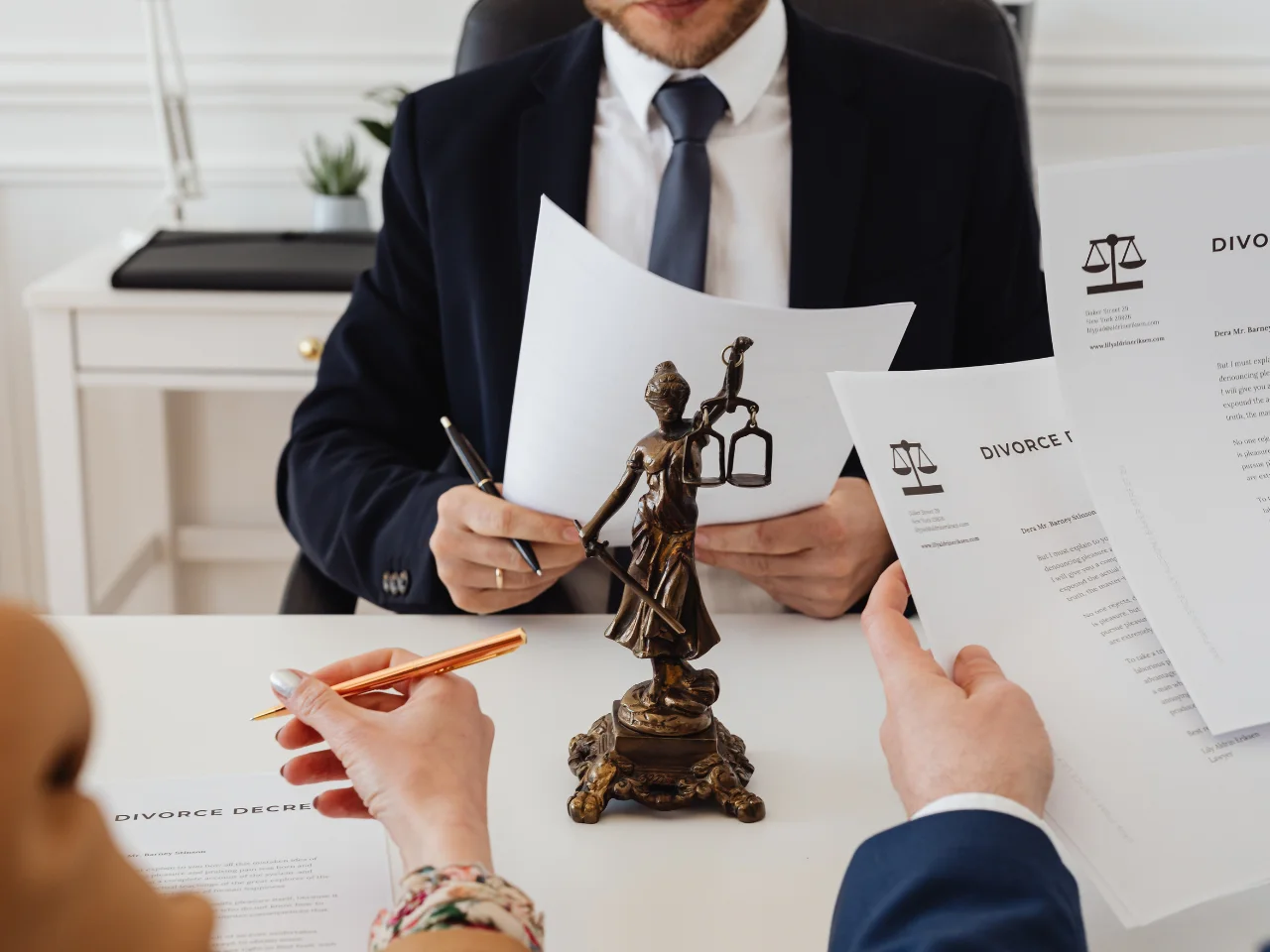 Lawyer reviewing divorce documents with clients during a legal consultation in Canada.