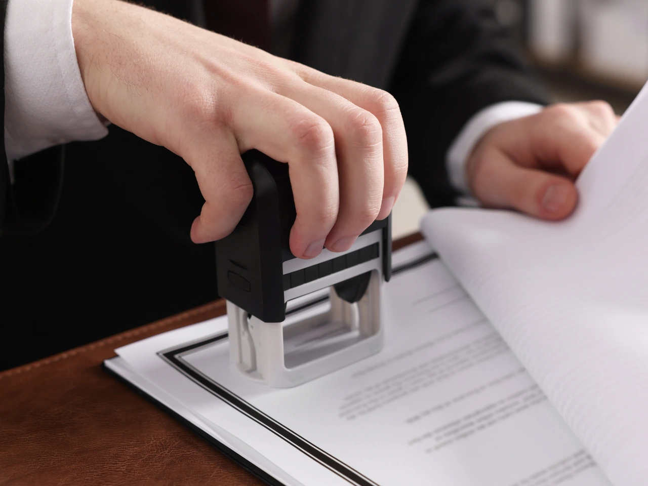 Official document being stamped during the document preparation process.