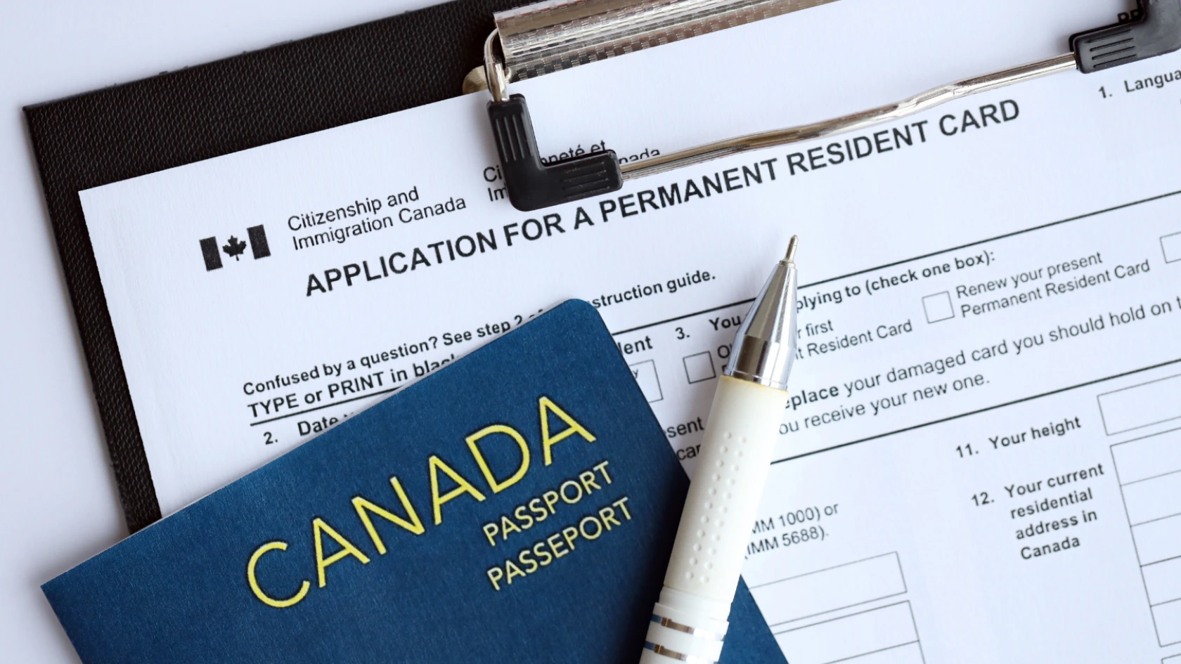 Canadian passport with Permanent Resident Card renewal application form.