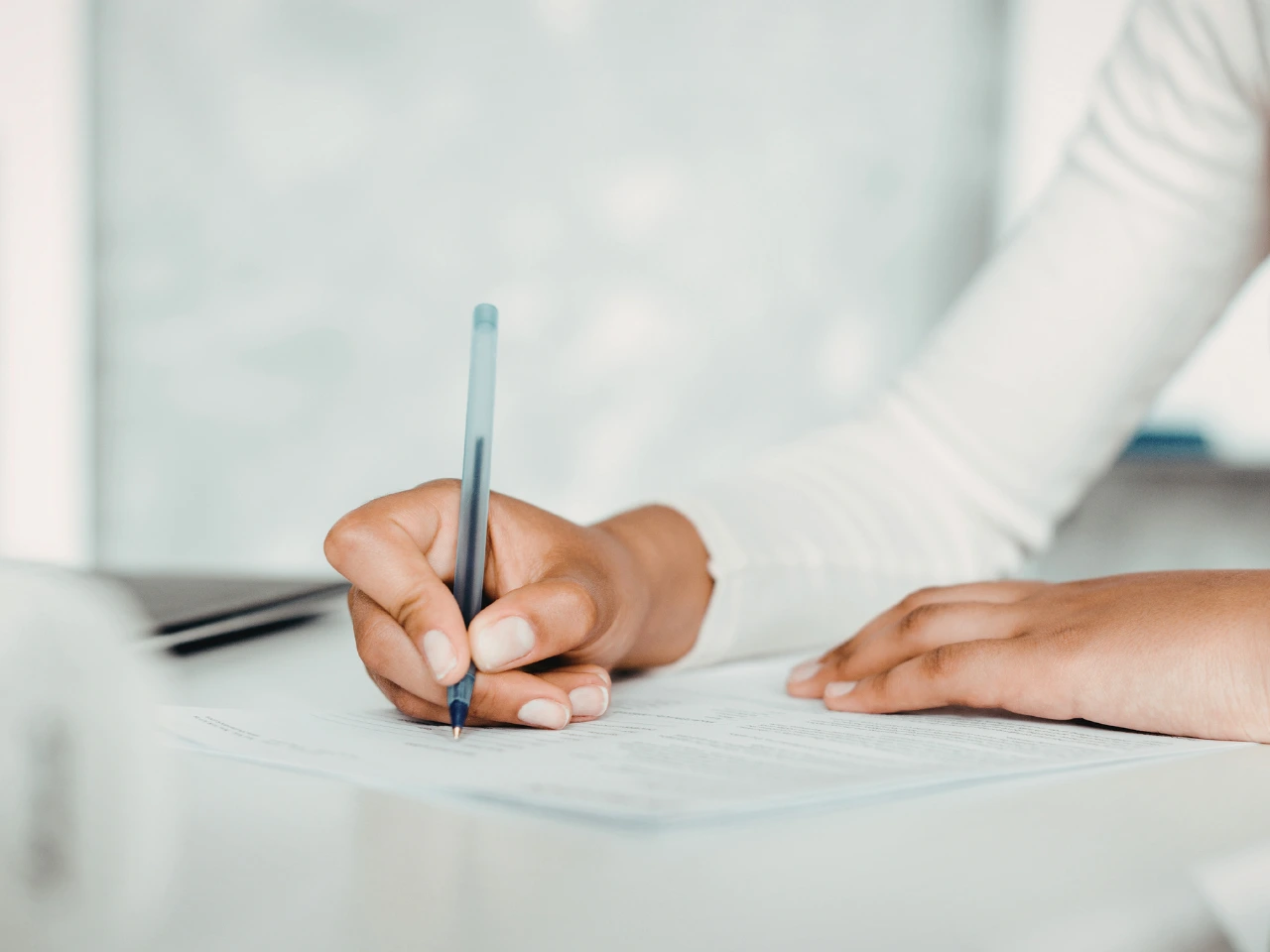 Applicant completing forms for a PR Card renewal application.