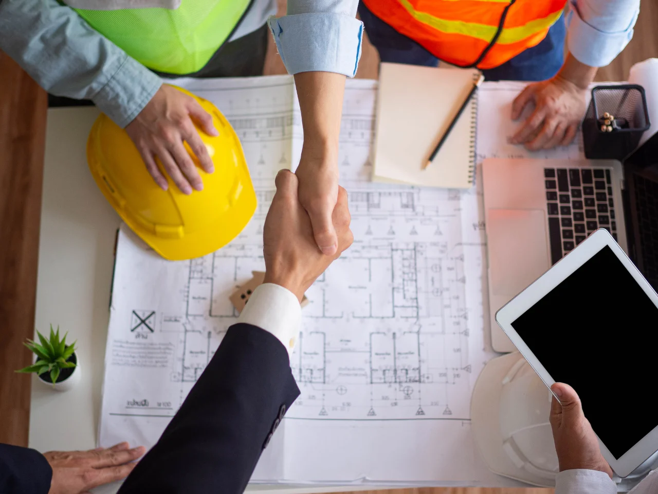 Engineers reviewing architectural plans and documents during a project meeting.