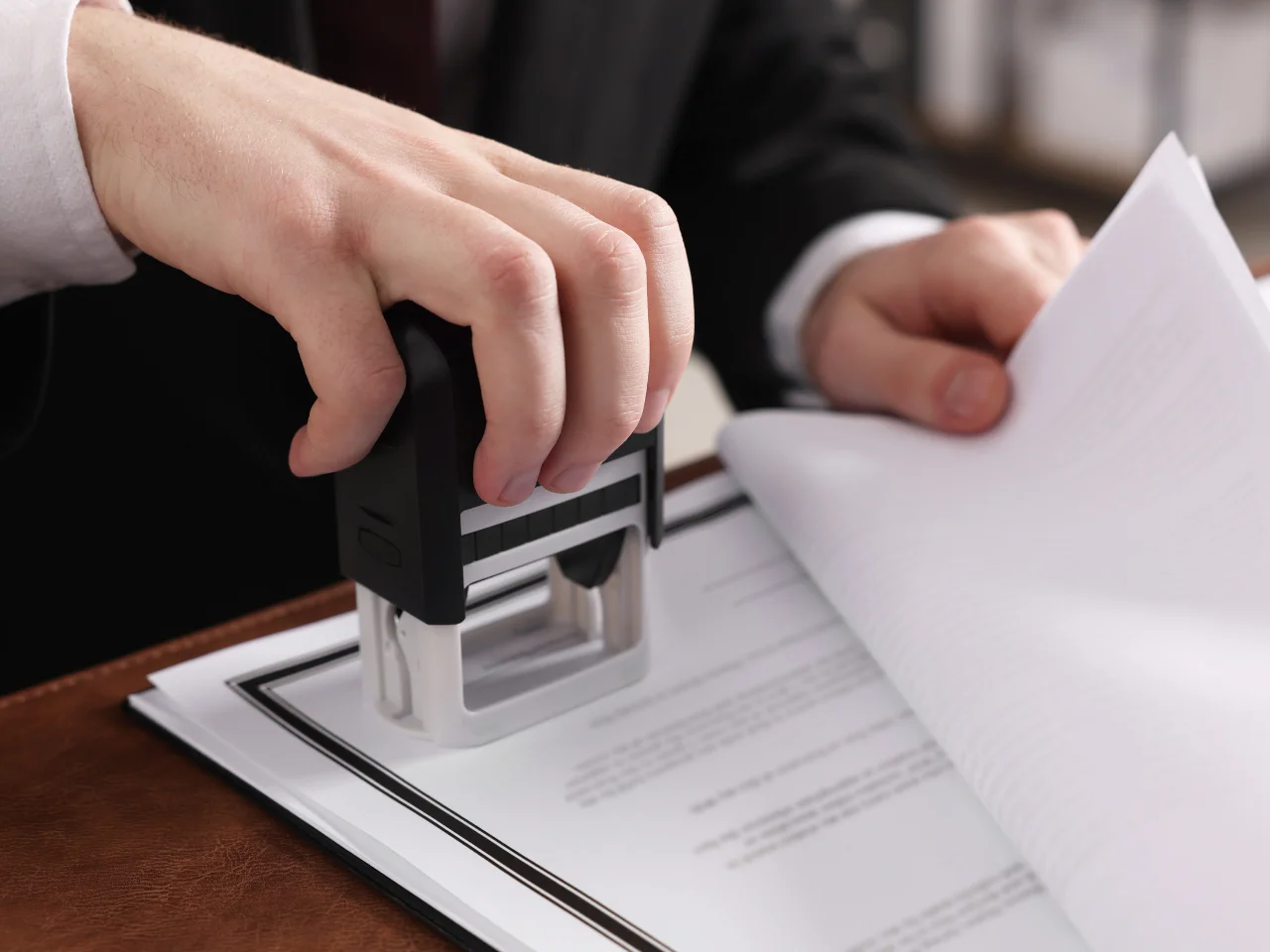 Official documents being stamped during the Canadian document authentication and UAE attestation process.