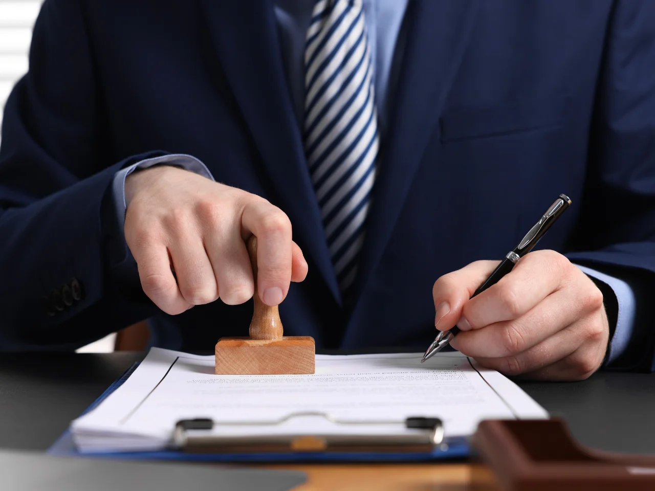 Professional stamping and signing official documents for UAE immigration, visa, and document legalization requirements.