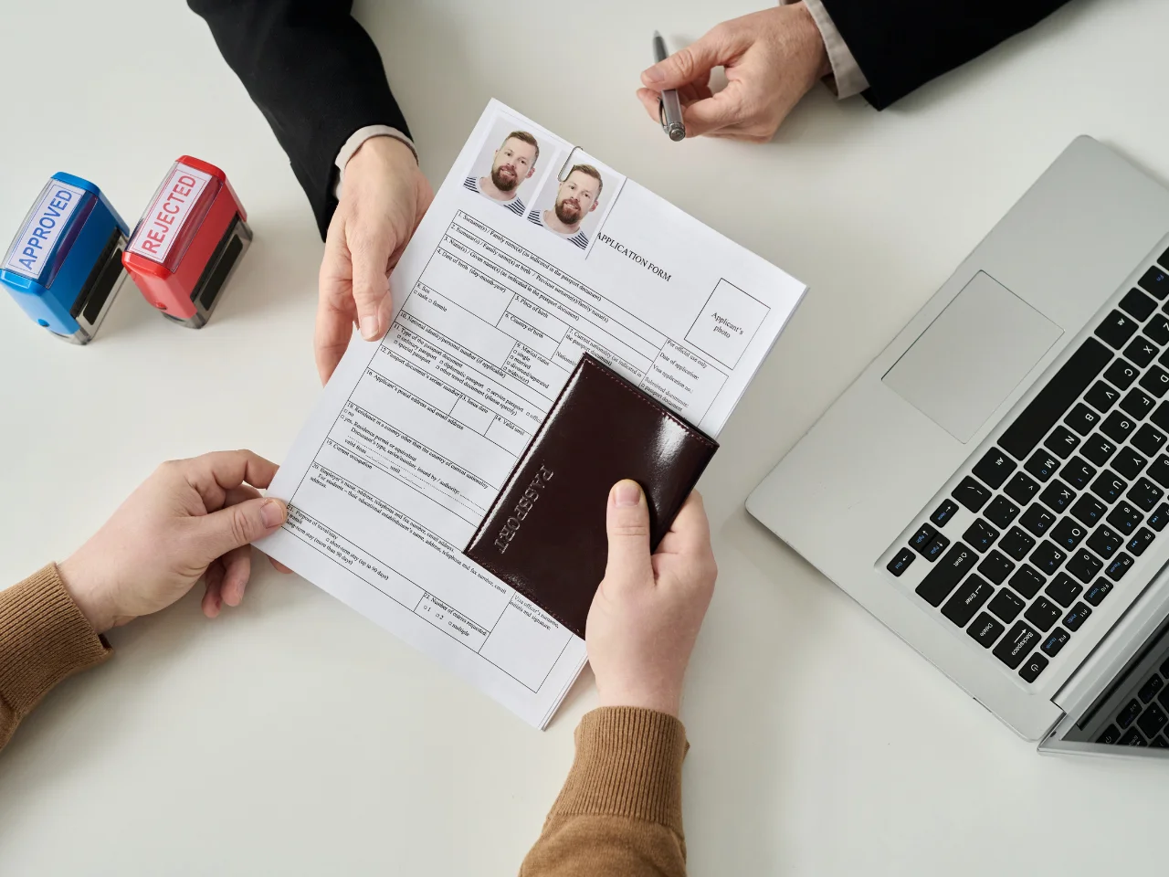 Applicant submitting passport and educational documents for WES credential evaluation and Canadian immigration.