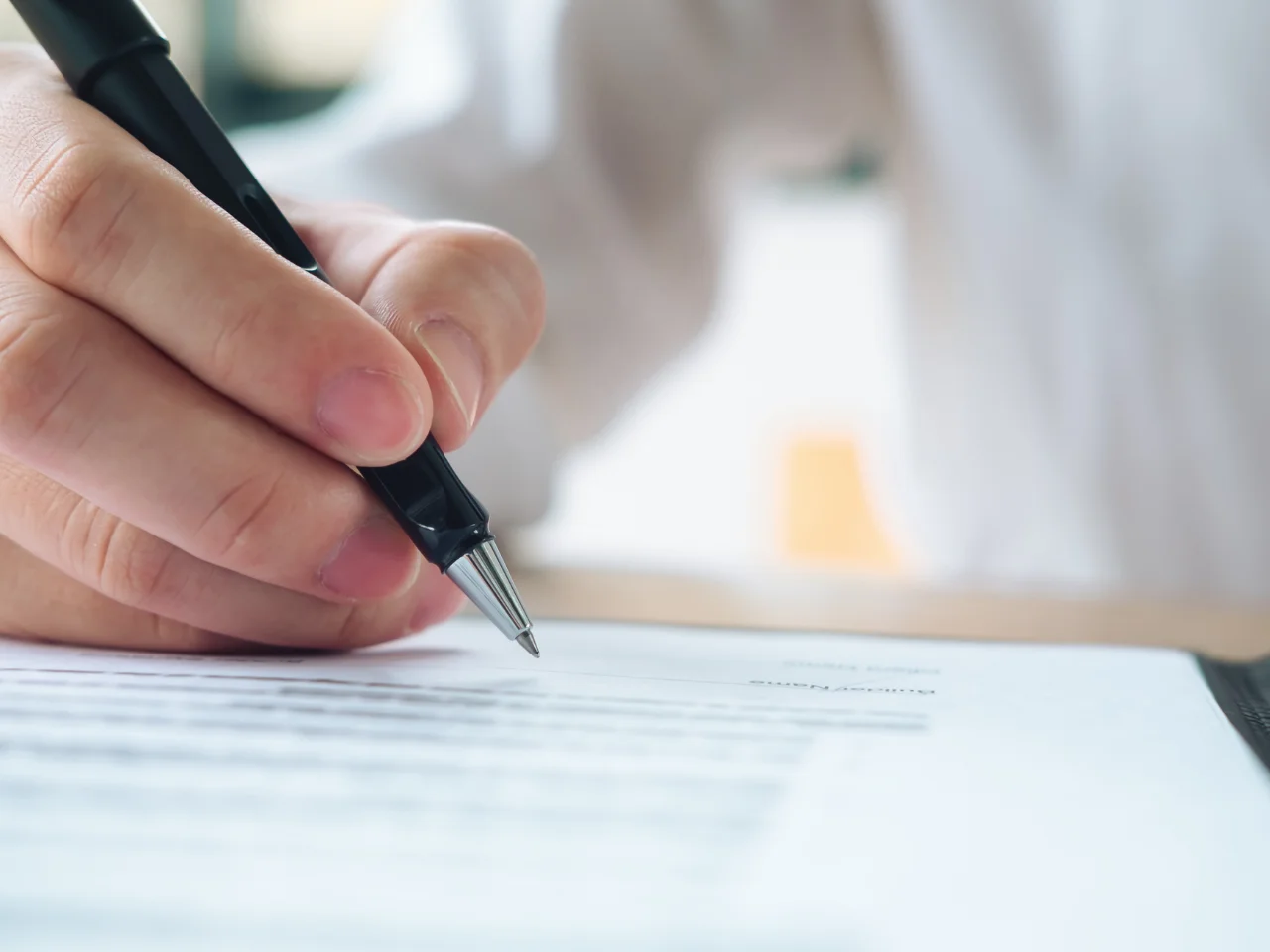 Signing official documents for certified translation and immigration applications.