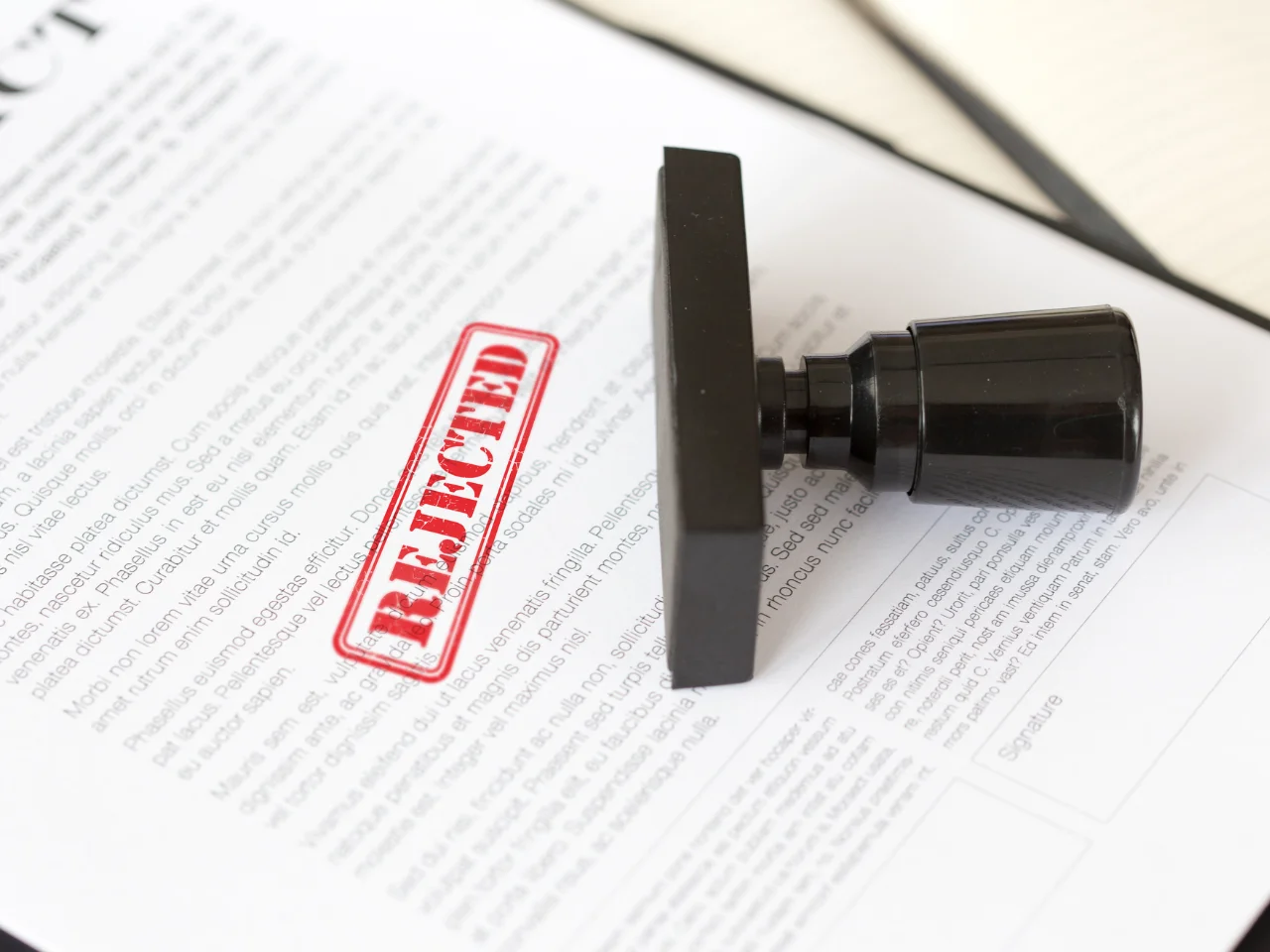 Rejected stamp on a document highlighting common immigration application errors.